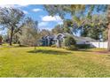 House with a large front yard and landscaping at 5579 Se 44Th Cir, Ocala, FL 34480