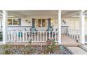 Inviting front porch with white railings and comfortable seating at 8420 Sw 93 Ln # E, Ocala, FL 34481