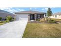 One-story house with a white garage door and a front yard at 8761 Sw 79Th Loop, Ocala, FL 34481