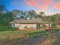 House showcasing a sunroom addition and expansive backyard at 9050 Sw 190Th Cir, Dunnellon, FL 34432