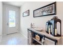 Bright entryway with decorative console table and elegant glass door at 9474 Sw 52Nd Loop, Ocala, FL 34481