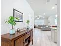 Open concept living area with gray sectional sofa and wood console table at 9474 Sw 52Nd Loop, Ocala, FL 34481