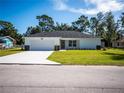 Newly built home with white siding, a two-car garage, and a well-manicured lawn at 12137 Se 89Th Ter, Belleview, FL 34420