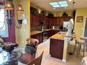 Spacious kitchen with dark wood cabinets, granite countertops, and island at 13300 Se 97Th Terrace Rd, Summerfield, FL 34491