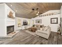 Cozy living room featuring a fireplace and wood accent ceiling at 13740 Sw 49Th Pl, Ocala, FL 34481