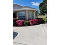 Side view of the house with beautiful pink flowers at 15440 Sw 14Th Avenue Rd, Ocala, FL 34473
