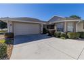 House exterior showcasing a two-car garage and neat landscaping at 15440 Sw 14Th Avenue Rd, Ocala, FL 34473