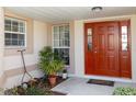 Inviting front entrance with a red door and potted plants at 15440 Sw 14Th Avenue Rd, Ocala, FL 34473