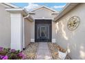 Front entry with a screened door and decorative compass at 15692 Sw 11Th Court Rd, Ocala, FL 34473