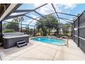 Relaxing screened pool and jacuzzi with waterfall feature at 15692 Sw 11Th Court Rd, Ocala, FL 34473