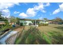 Large backyard with covered patio, mature trees, and plenty of space at 2004 Ne 52Nd St, Ocala, FL 34479
