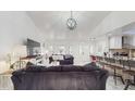 Living room with a view into the kitchen and access to the dining area at 21668 Sw Peach Blossom St, Dunnellon, FL 34431