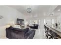 Open living space with marble floors, comfortable seating, and a modern fireplace at 21668 Sw Peach Blossom St, Dunnellon, FL 34431