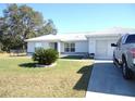 Front yard view of house with truck parked in driveway at 221 Locust Ln, Ocala, FL 34472