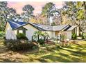 Beautiful exterior view of a modern home with lush landscaping and a well-maintained lawn at 4400 Sw 20Th Ave, Ocala, FL 34471