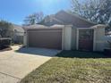 Single-story home featuring a spacious two-car garage and well-manicured lawn, creating a welcoming exterior at 4542 Ne 4Th St, Ocala, FL 34470