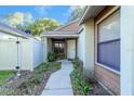 Front entry with a walkway, landscaping, and white fence at 4542 Ne 4Th St, Ocala, FL 34470