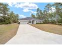 One story home with a long driveway and two car garage at 4585 Sw 112Th Ln, Ocala, FL 34476