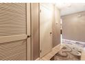 Apartment hallway with light brown flooring and louvered doors at 512 Bahia Cir # 512B, Ocala, FL 34472