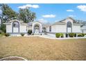 Front view of a single-story house with a walkway at 7528 Sw 102Nd Loop, Ocala, FL 34476