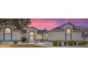 Charming single-story home with a well-manicured lawn and lovely curb appeal at dusk at 7528 Sw 102Nd Loop, Ocala, FL 34476