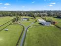 Aerial view of the property, highlighting the home, arena, and barn at 7675 W Highway 326, Ocala, FL 34482