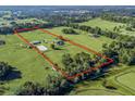 Aerial view of a horse farm with house and barn at 7675 W Highway 326, Ocala, FL 34482