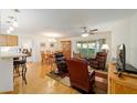 Spacious living area with hardwood floors, comfortable seating, and large windows at 8086 Sw 81St Loop, Ocala, FL 34476