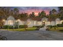 Stunning home exterior at dusk, showcasing architectural details and landscaping at 995 Sw 37Th Place Rd, Ocala, FL 34471