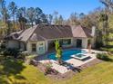Inviting pool and spa area with lush landscaping and spacious backyard at 995 Sw 37Th Place Rd, Ocala, FL 34471