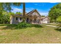 House exterior with a tree-lined front yard at 10320 Sw 103Rd Ct, Ocala, FL 34481