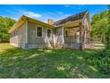 Side view of house showcasing stonework and landscaping at 10320 Sw 103Rd Ct, Ocala, FL 34481