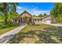 Two-story house with a large yard and attached garage at 10320 Sw 103Rd Ct, Ocala, FL 34481