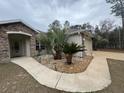 House exterior with walkway and landscaping at 1060 Sw Big Tree Rd, Dunnellon, FL 34431