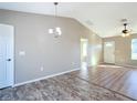 Dining area with vinyl plank flooring and a modern chandelier at 10856 Sw 79Th Ave, Ocala, FL 34476