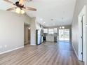 Open concept living room and kitchen with vinyl plank flooring and high ceilings at 10856 Sw 79Th Ave, Ocala, FL 34476