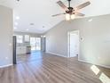 Open living room with vinyl plank flooring, high ceilings, and ceiling fan at 10856 Sw 79Th Ave, Ocala, FL 34476