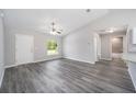 Spacious living room featuring grey vinyl plank flooring and a ceiling fan at 117 Nw Sparrow Rd, Dunnellon, FL 34431