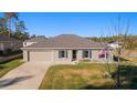 Single-story house with a gray roof, light gray siding, and a spacious yard at 13198 Sw 29Th Cir, Ocala, FL 34473