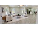 Bright living room with modern furniture and decor, flowing into an open-concept kitchen at 13253 Se 35Th Ct, Belleview, FL 34420