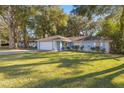 Ranch style home with a spacious yard and mature trees at 2340 Ne 43Rd St, Ocala, FL 34479