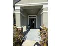 Front entrance with gray door and stone accents at 25 Nw 113Th Cir, Ocala, FL 34482