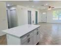 Spacious open-concept with views of the front door, tile flooring, and a modern kitchen island at 2881 Se 140Th Pl, Summerfield, FL 34491