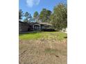 House with a yard and a lamp post at 3 Maple Run, Ocala, FL 34472