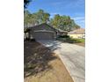 Front view of a house with a driveway and garage at 3 Maple Run, Ocala, FL 34472