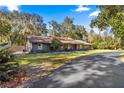 House exterior showcasing gray siding and a paved driveway at 3650 Se 22Nd Ave, Ocala, FL 34471