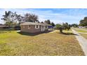 Side view of a tan house with a large yard at 3766 Sw 147Th Lane Rd, Ocala, FL 34473