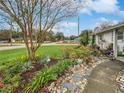 Landscaped walkway leading to house; mature trees and plants at 3805 Se 138Th Pl, Summerfield, FL 34491