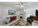 Bright living room featuring fireplace and open floor plan at 3805 Se 138Th Pl, Summerfield, FL 34491