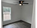 Well-lit bedroom featuring a window, ceiling fan, and wood-look flooring at 5363 Nw 3Rd St, Ocala, FL 34482